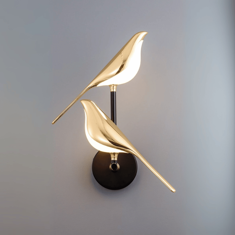 Gold LED wall light with magnetic bird design