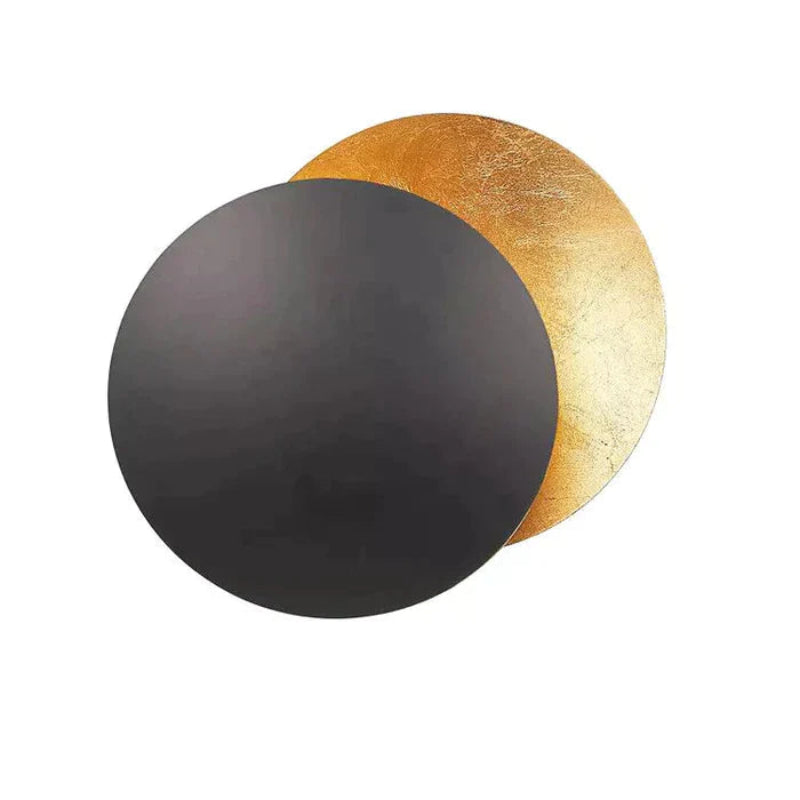 Gold eclipse-inspired LED wall light with rotating disc