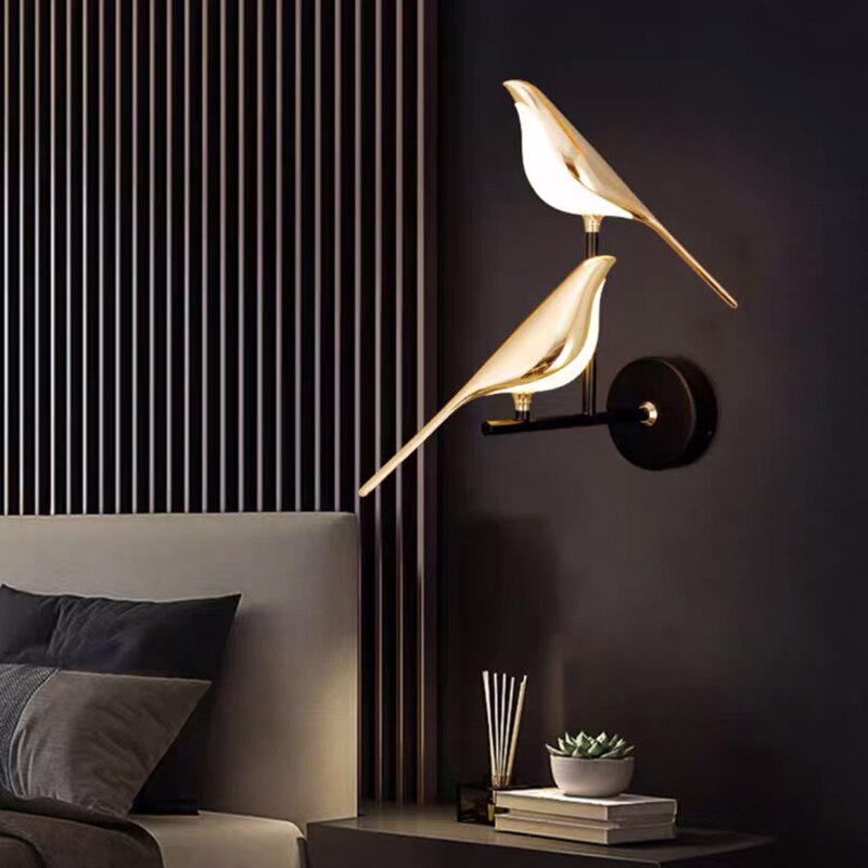 Gold LED wall light with magnetic bird design