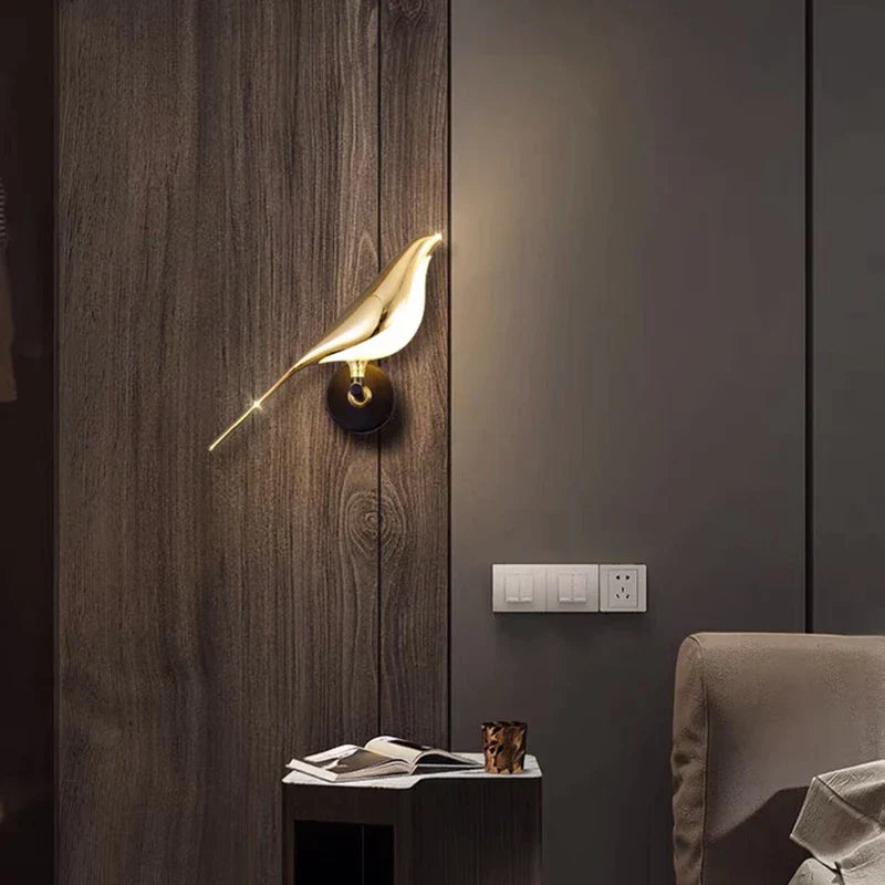 Gold LED wall light with magnetic bird design