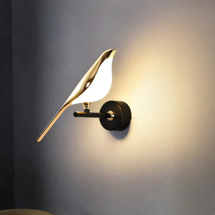 Gold LED wall light with magnetic bird design