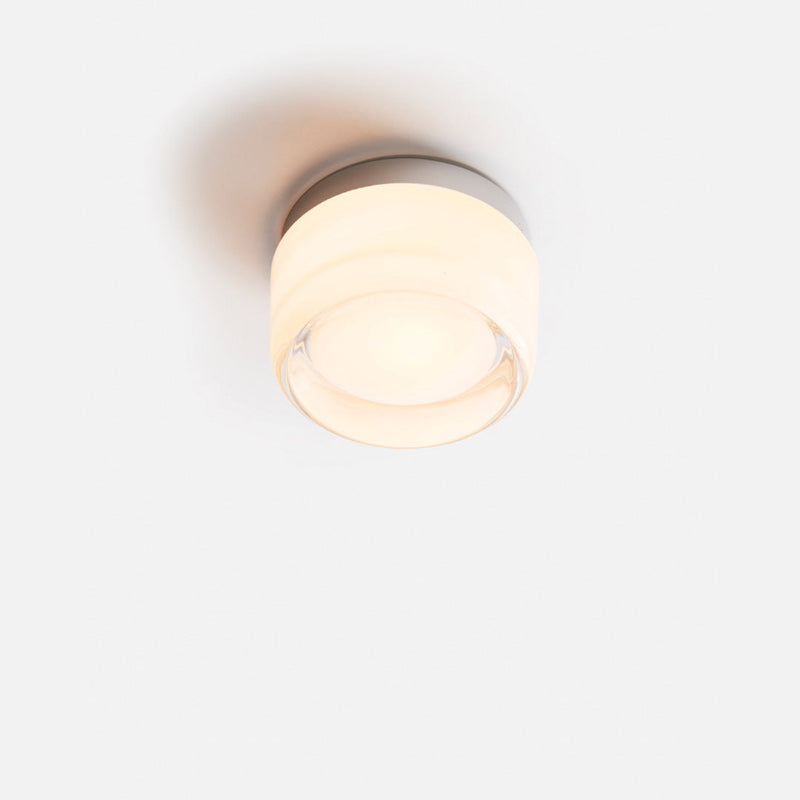 Elegant black and gold wall light with dimpled glass shade