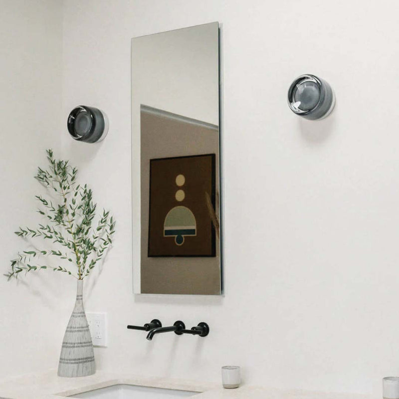 Elegant black and gold wall light with dimpled glass shade