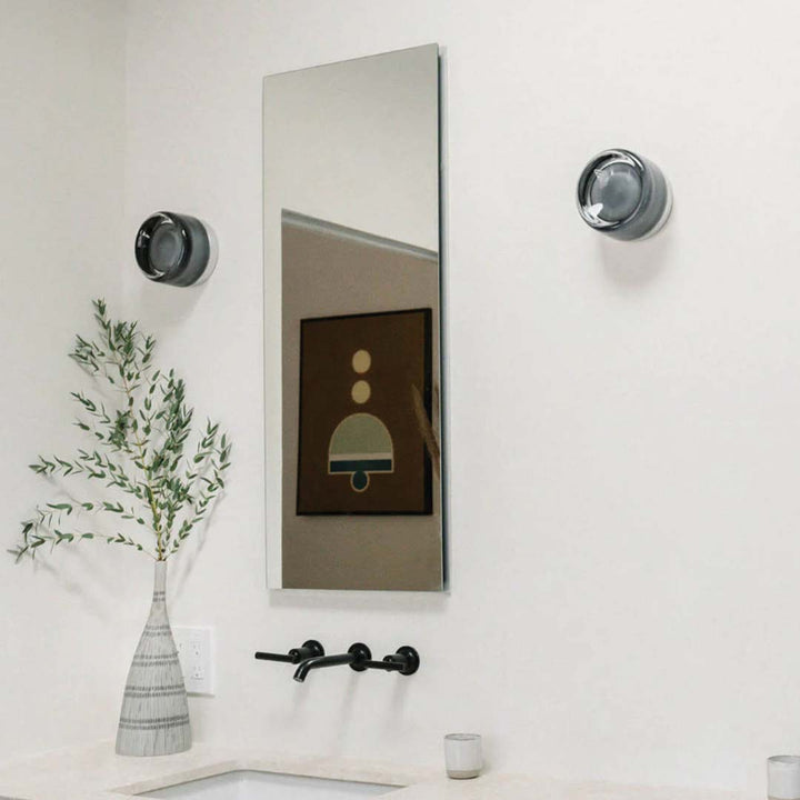Elegant black and gold wall light with dimpled glass shade