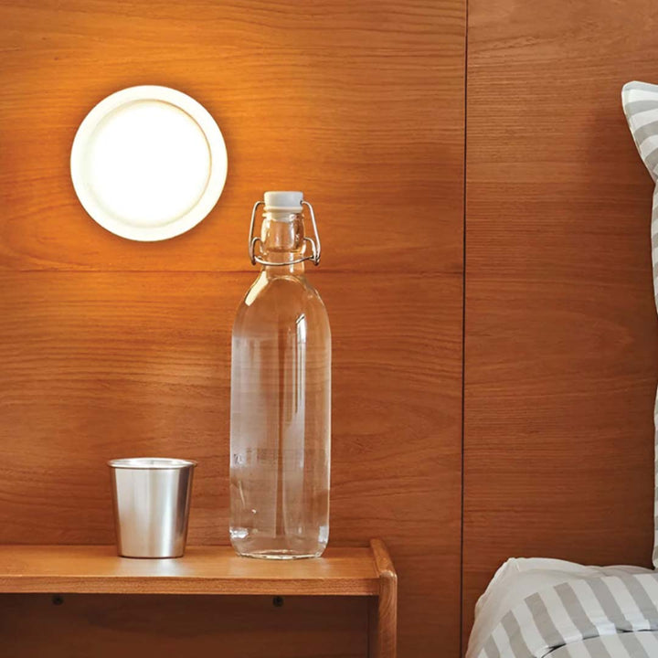 Elegant black and gold wall light with dimpled glass shade
