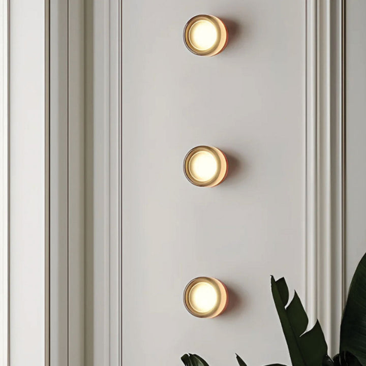 Elegant black and gold wall light with dimpled glass shade